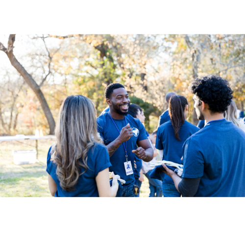 Small group of people wearing matching blue shirts outside
