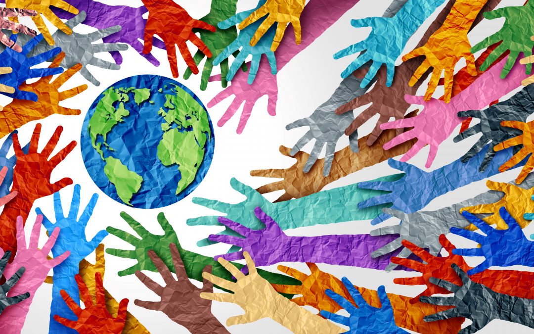 A concept of diversity and crowd cooperation as diverse hands (all different colors) surround the world; illustration looks like paper material