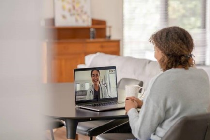 Photo of a woman on a telehealth call with her doctor