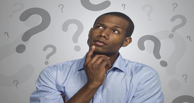 Man thinking with question marks around him